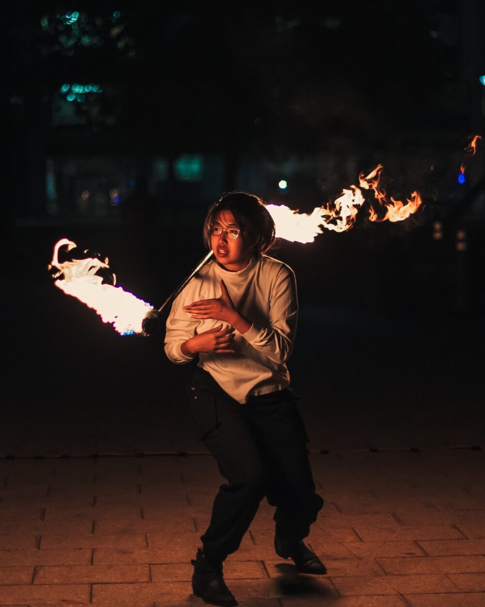woman fire spinning a dragon staff