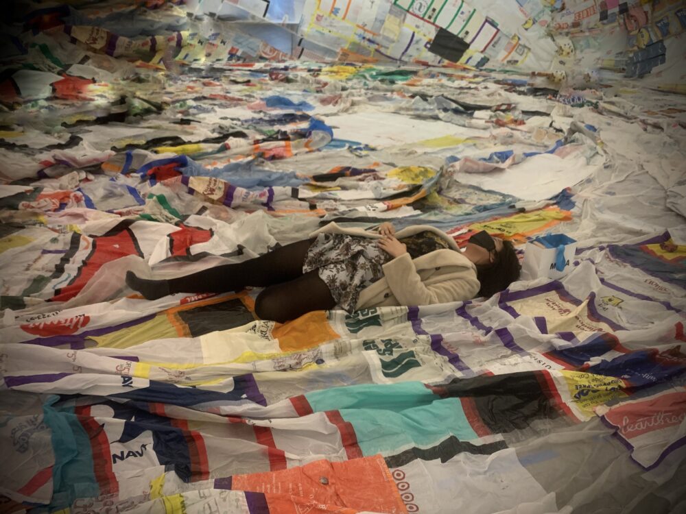 woman laying in a pile of layered fabrics