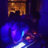 2 people djing a party