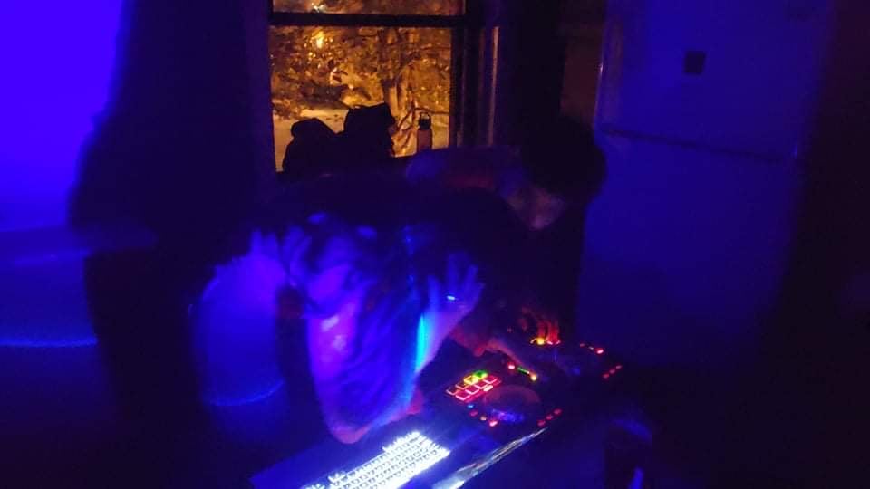 2 people djing a party