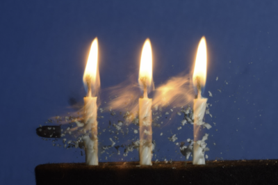 a bullet flying through 3 lit candles