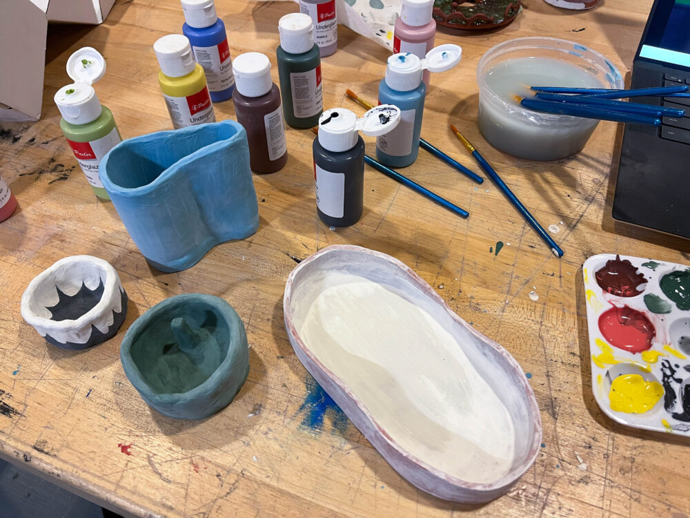a picture of various matte clay trays and mini pots painted in various colors (blue, green, etc.)