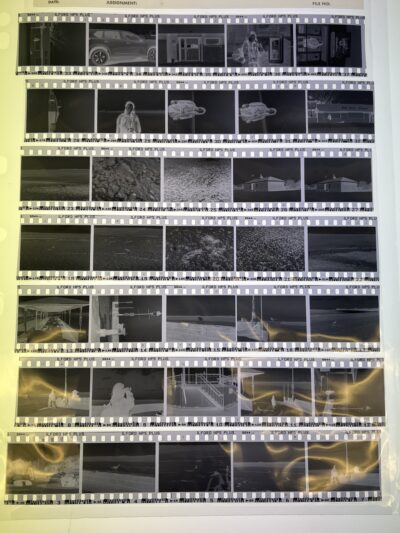 a photo of a glossy plastic sleeve with 7 strips of 5 film negatives slotted into it