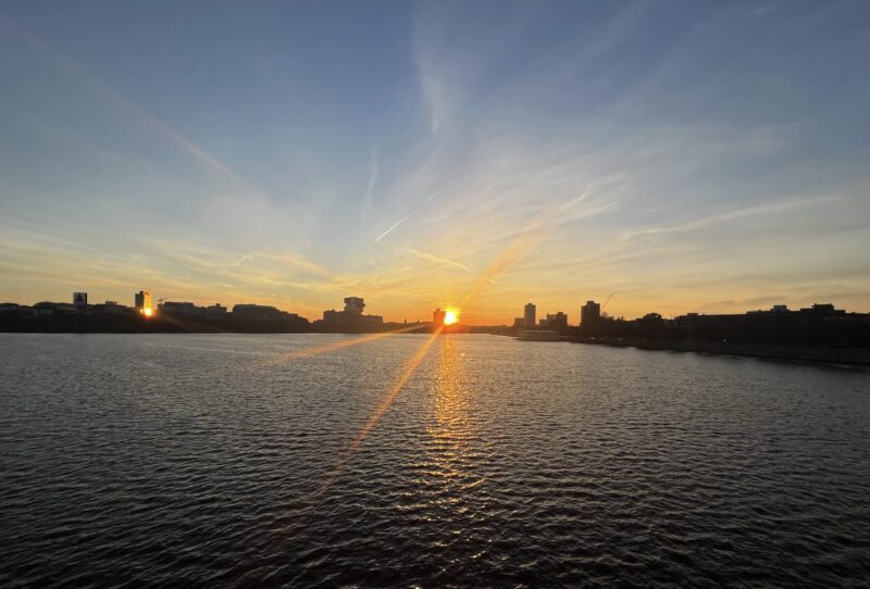 Sunset on the Charles river with buildings and the river in the picture.
