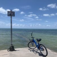 a bike parked at the edge of an oceanside dock