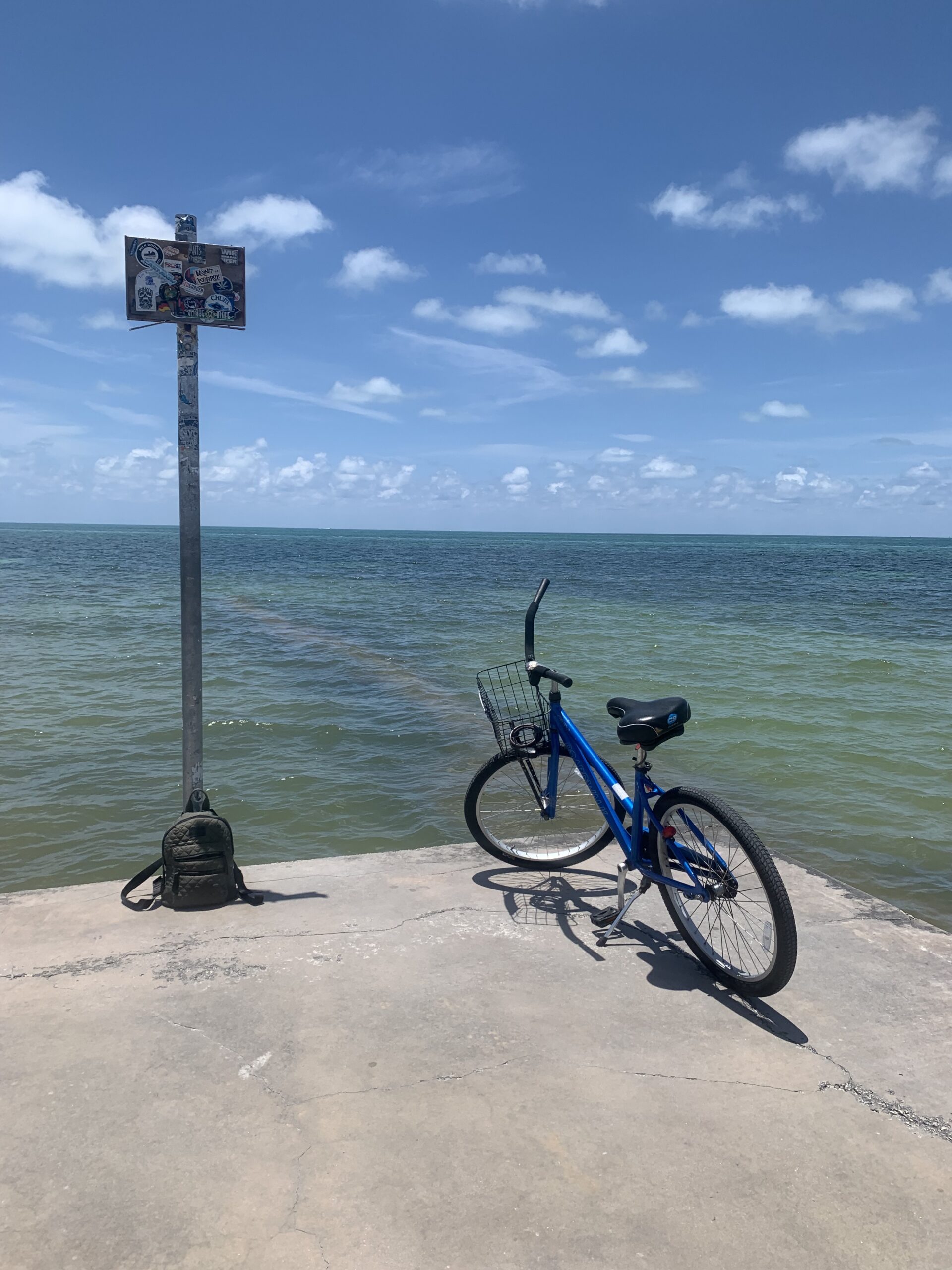 a bike parked at the edge of an oceanside dock