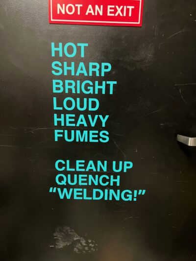 vinyl words that read "hot, sharp, bright, loud, heavy,, fumes, clean up, quench welding"