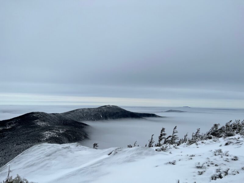 more mountains peeking through cloud cover