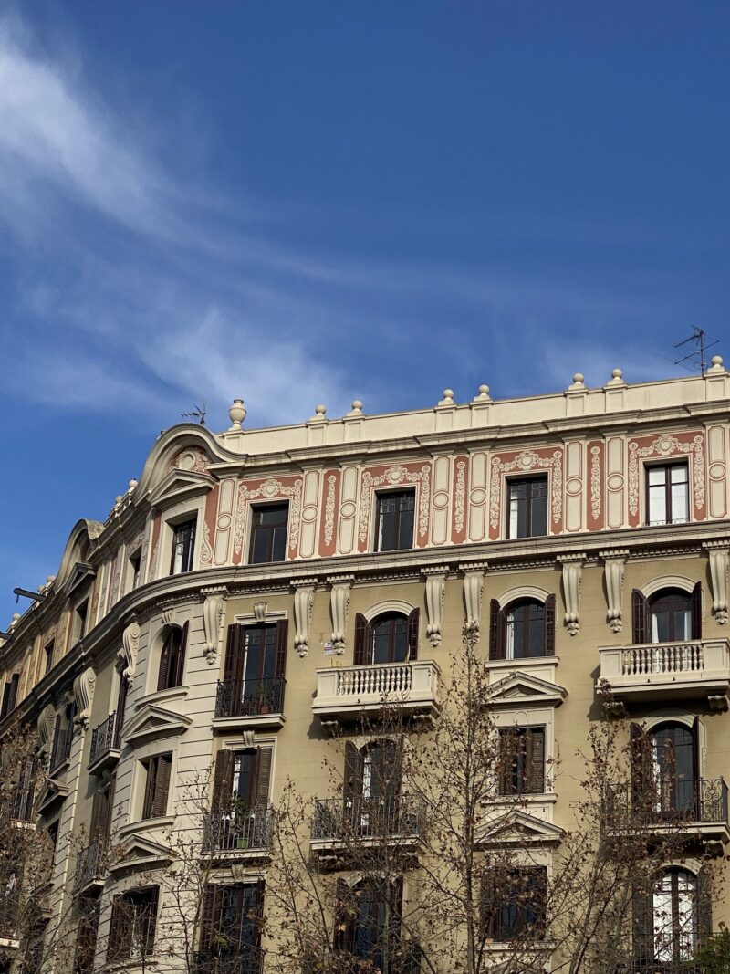 side of a building with archaic windows and arches