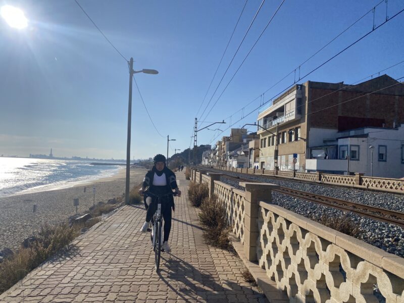 woman on bike next to the ocean