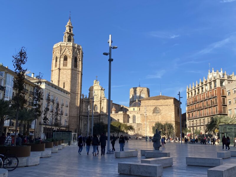 city square with old buildings and square stone seats