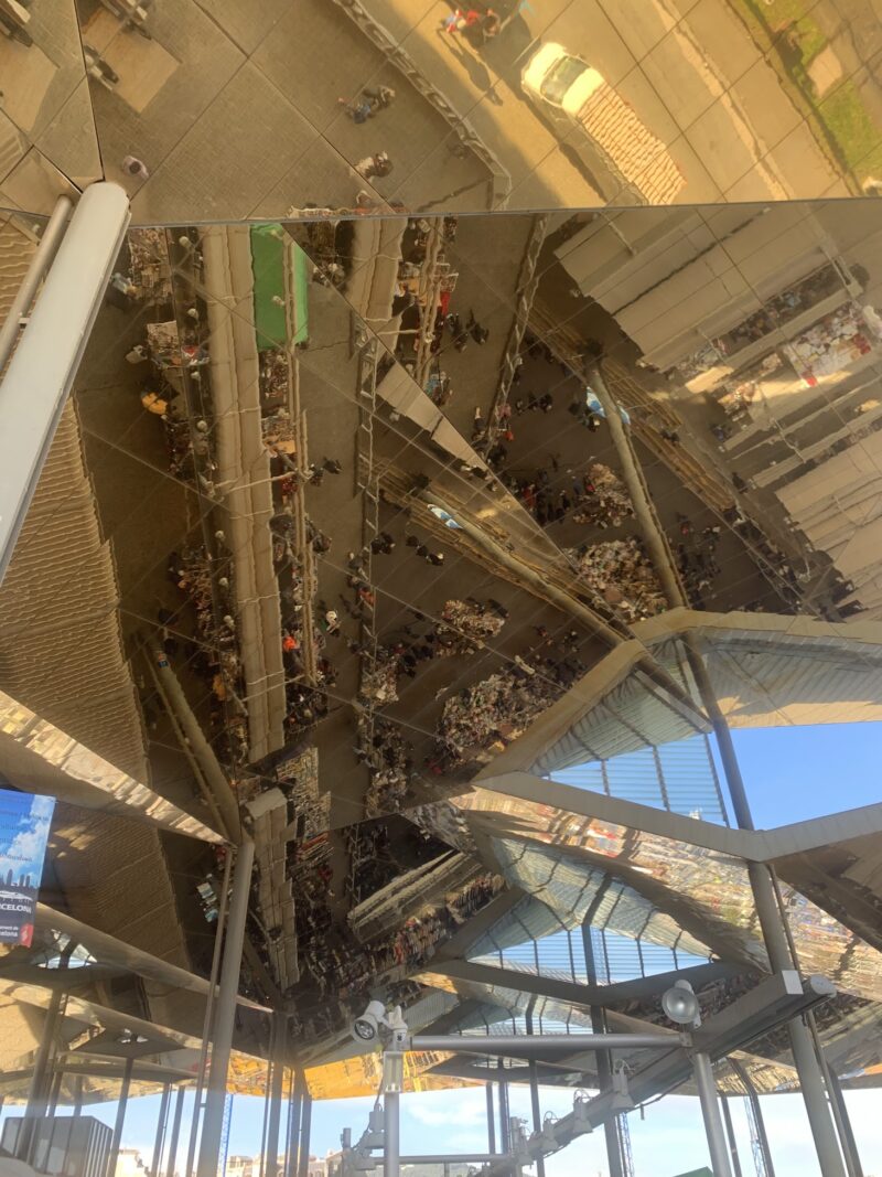 a ceiling with mirrors on it, reflecting a flea market