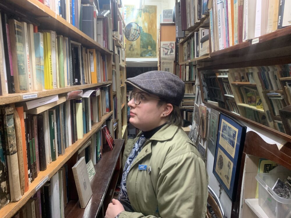 person standing between two rows of books