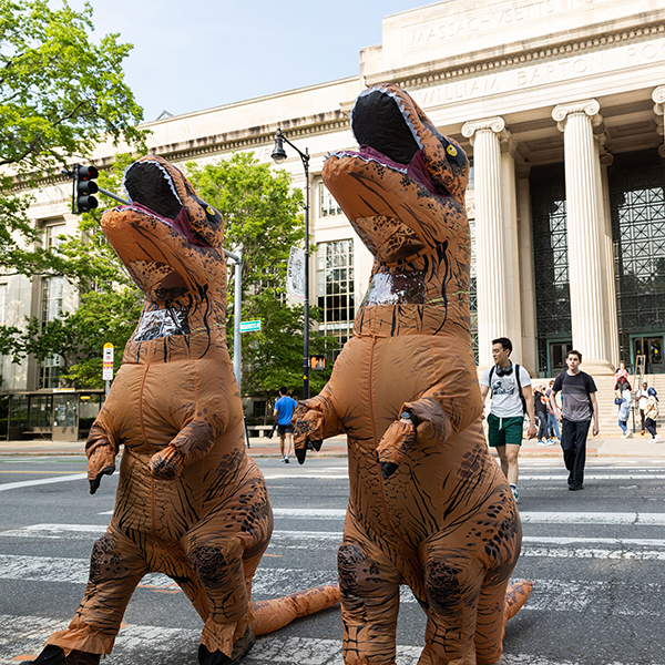 two students in dinosaur costumes 