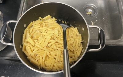 Image of lots of penne pasta in a pot.