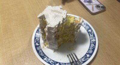 Image of half-eaten vanilla cake on plate.