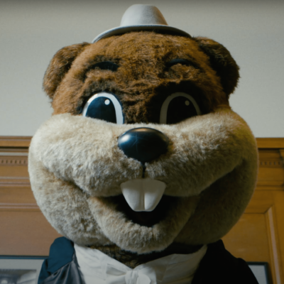 Tim the Beaver (the mascot costume) wearing a grey porkpie hat.
