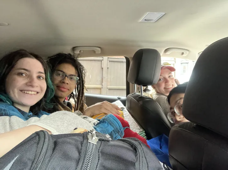 four people cramped in a car