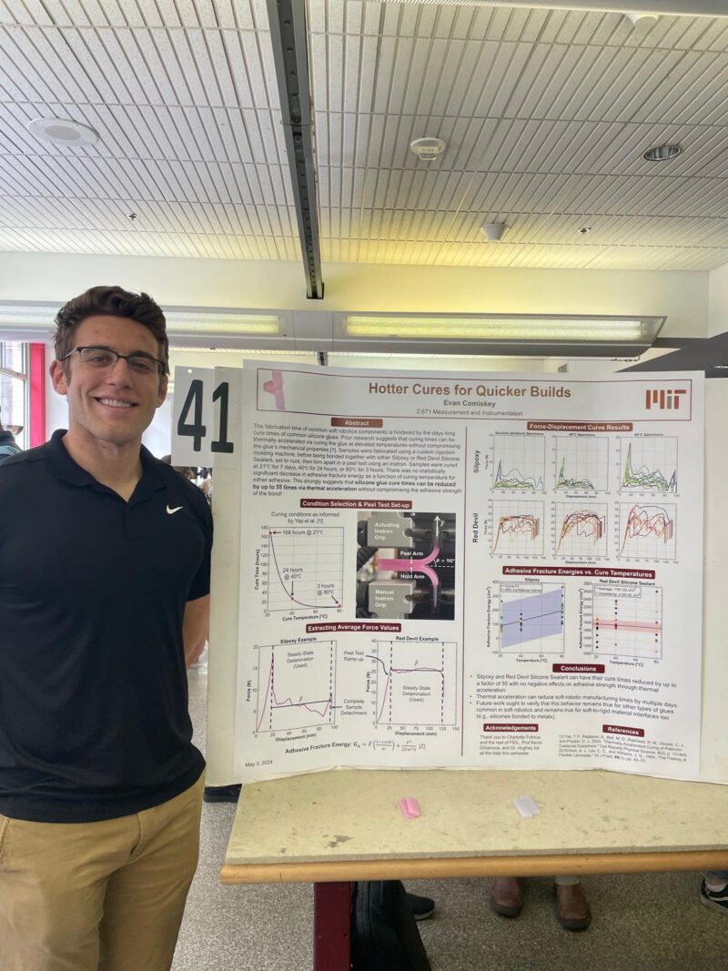 Presenter smiling in front of his poster.