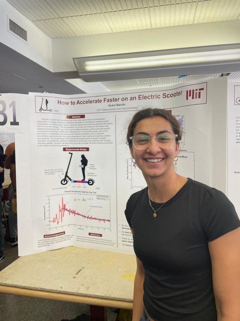 Presenter smiling in front of her poster.