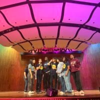 Student a cappella performers centered on stage at Kresge Auditorium