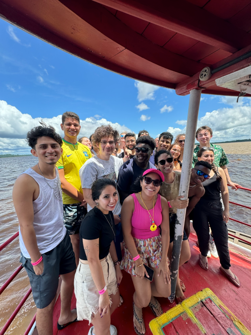 A group of around 14 students on a boat in Manaus, the members of the MISTI-Brazil Global Classroom program.