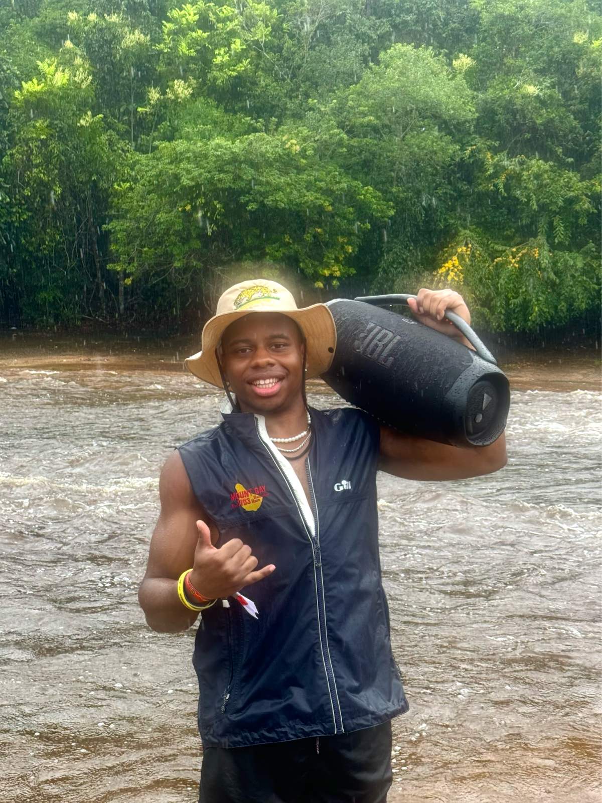 Andre standing in front of a river while it's raining, in a bucket hat and&hellip;