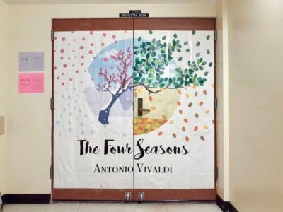 Door made into a poster advertising "The Four Seasons by Antonio Vivaldi" with four seasons shown on one tree