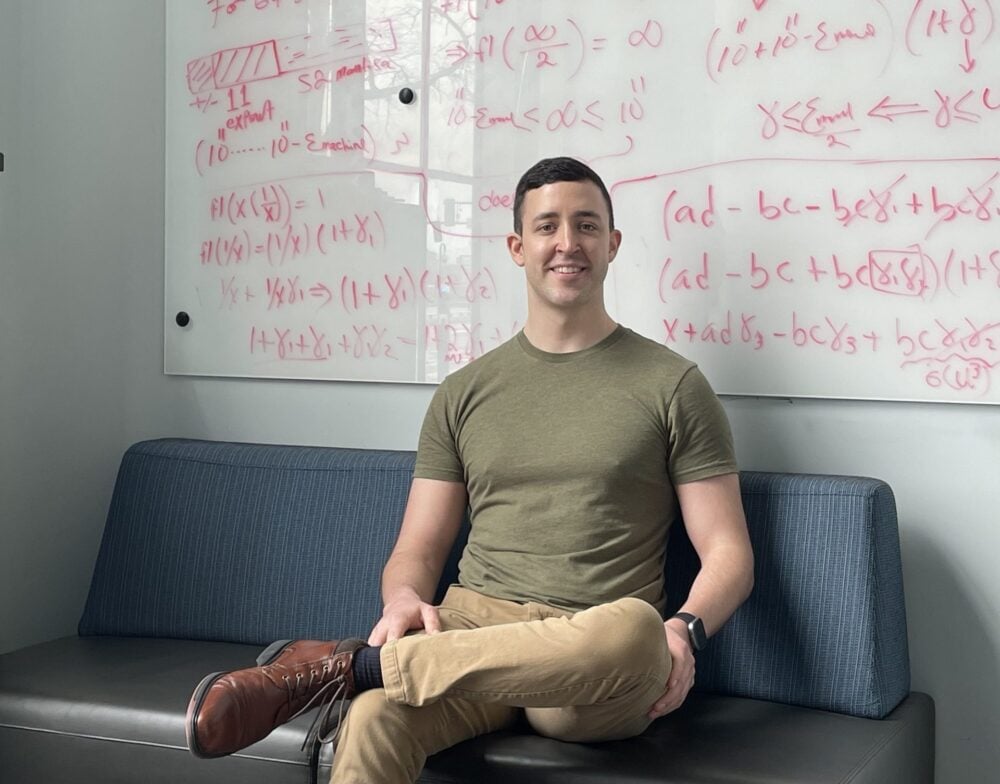 MIT student veteran Justin Cole pictured sitting on a couch on the MIT campus.