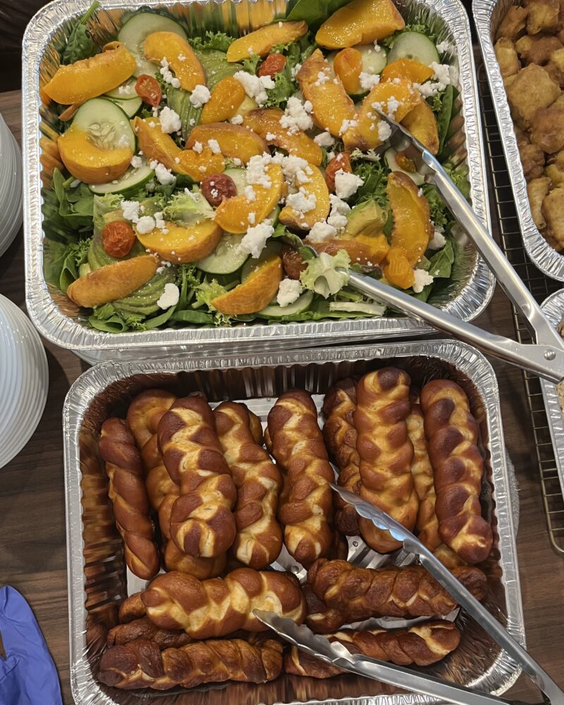 Salad with cucumber, peaches, tomatoes, feta. Pretzel braids.