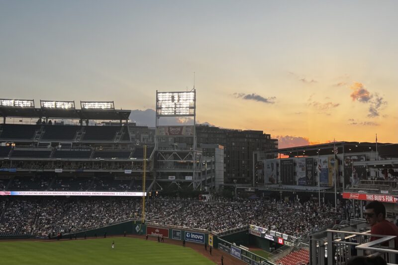 Baseball stadium with sunset in the background.