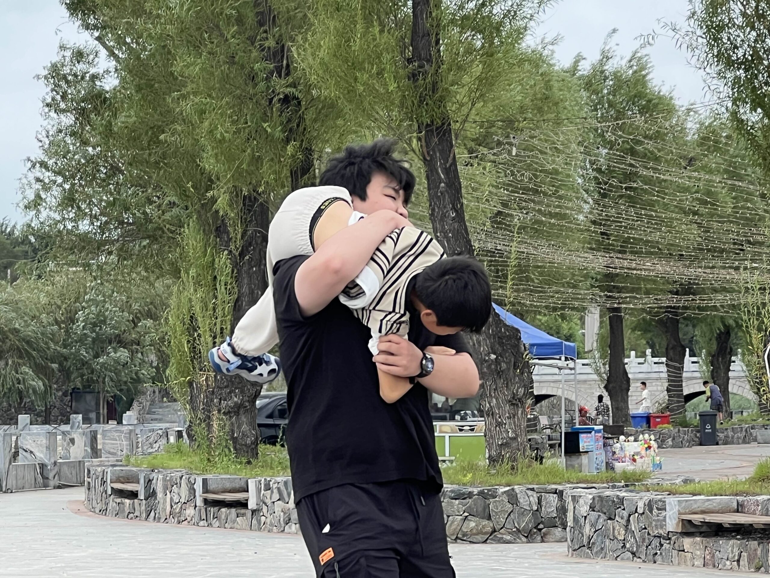 my cousin carrying my little brother like a sack of potatoes