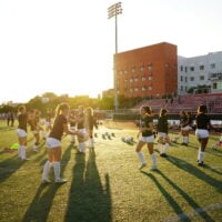 Soccer players juggling a ball.