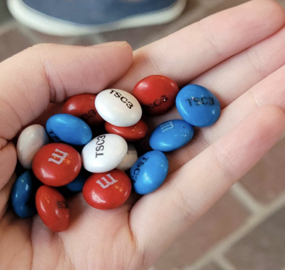 Red, white, and blue M&M's with "TSC3" printed on them