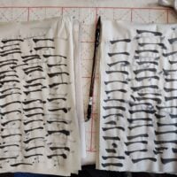 Two sheets of calligraphy filled with horizontal brush strokes