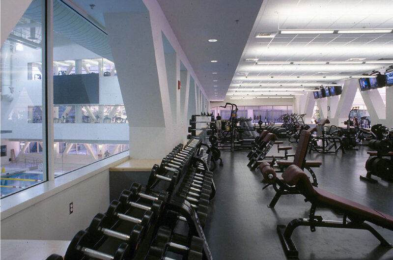 A picture of a gym with a bunch of free weights and machines