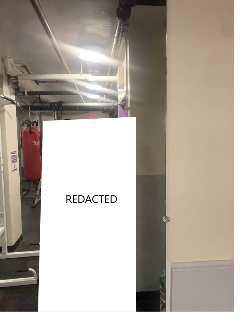 a picture of a dimly lit gym area with a boxing bag