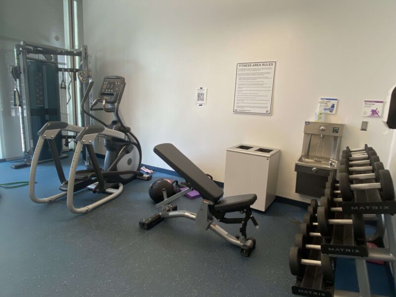 a picture of the side of a gym, with several machines