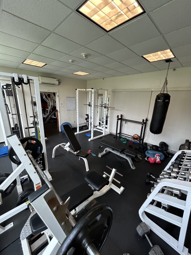 a picture of a spacious gym with several machines next to each other