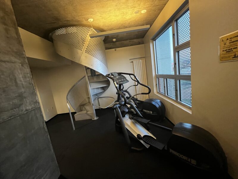 picture of a spiral staircase next to a treadmill