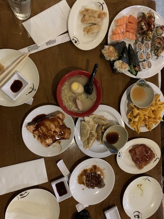 a wide variety of sushi and asian food on a table