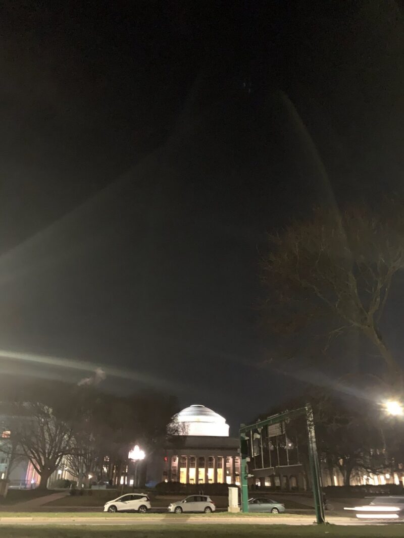 most of the picture is the blackness of light. the mit small dome, as well as the streetlamp, glow in the night.