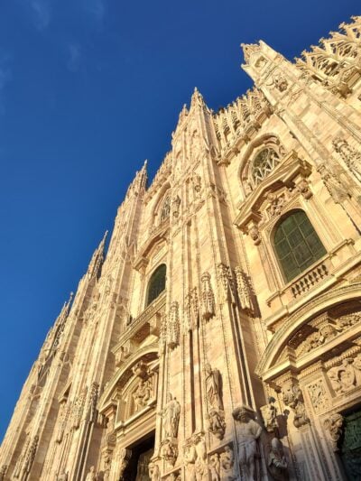 The Duomo in Milan, a tall cathedral with very detailed, sculpted features