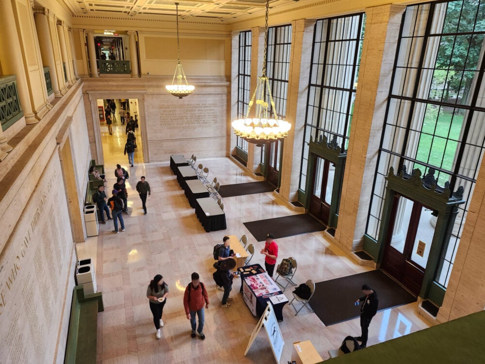 large open space with marble walls and several people