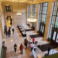 large open space with marble walls and several people