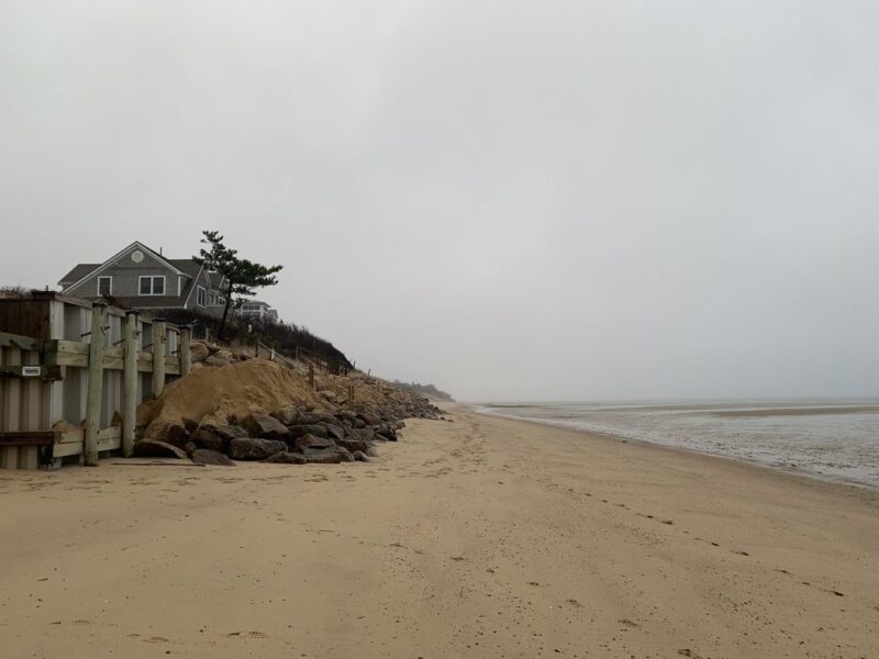 a house overlooking the sea on a cloudy day