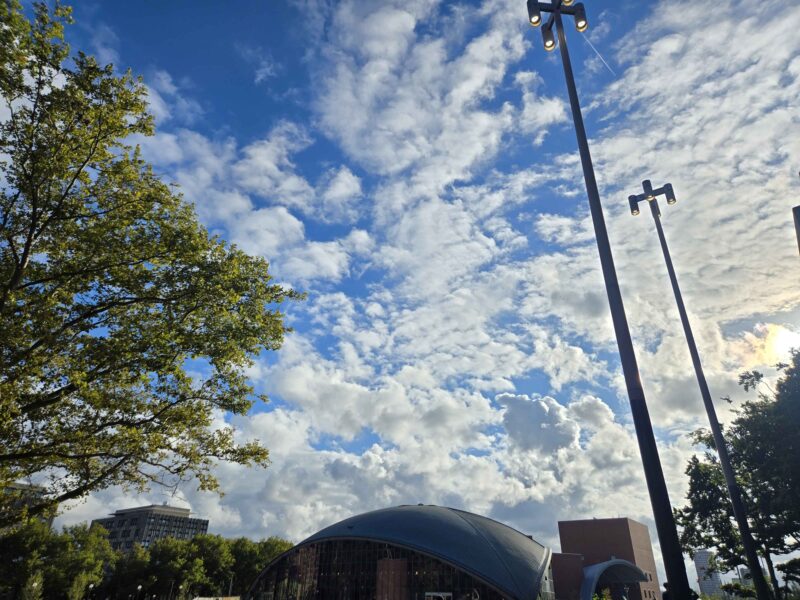 clouds on a blue sky stretch over kresge auditorium