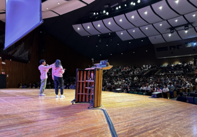 photo of two people (the directors) standing up on stage talking to the audience!