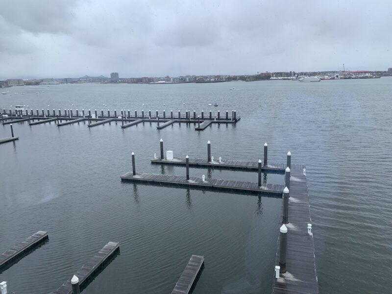a bunch of thin piers on the ocean on a cloudy day