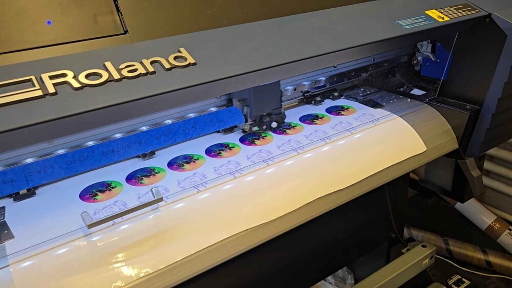 stickers in the process of being printed on a vinyl printer